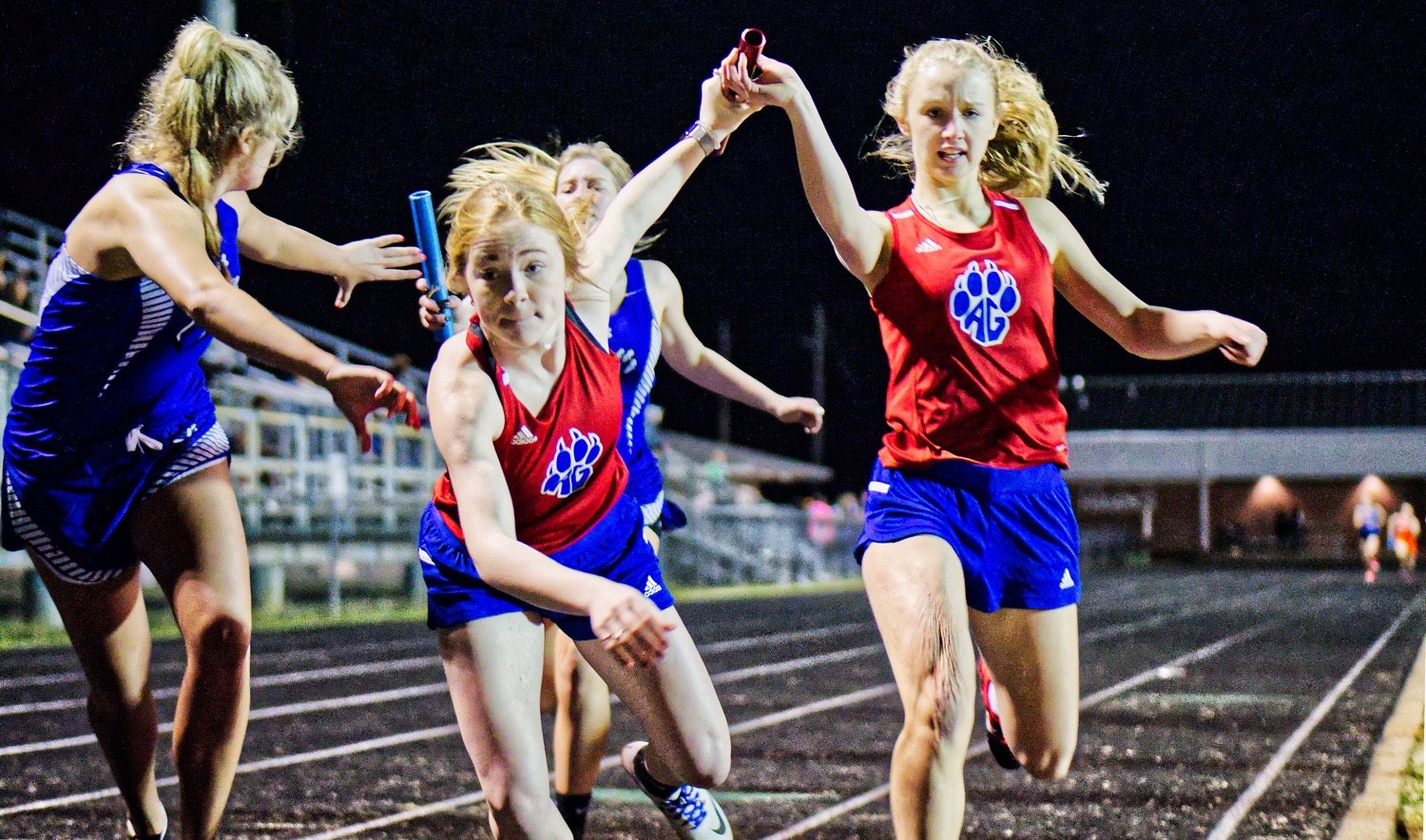 Bella Crawford hands off to Gracie Teel for the last leg of the 4x400m relay race, neck-and-neck with the Hawkins team. Teel closed out the win for the Alba-Golden team which was led off by Cacie Lennon and Kamrin Wright. [just a start - finish the album here]